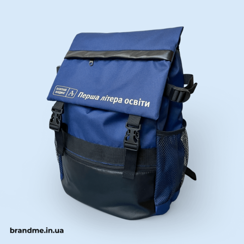 Синій рюкзак із логотипом Холдинг A+ та написом «Перша літера освіти»